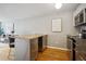Updated kitchen with stainless steel appliances and island with breakfast bar at 75 N Emerson St # 104, Denver, CO 80218