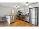 Well-equipped kitchen with stainless steel appliances and breakfast bar at 75 N Emerson St # 104, Denver, CO 80218