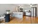 This kitchen features stainless steel appliances, warm lighting, and a breakfast bar with stool seating at 75 N Emerson St # 104, Denver, CO 80218