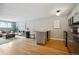 Open floor plan with hardwood floors, and view into the living room at 75 N Emerson St # 104, Denver, CO 80218