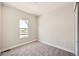 Neutral bedroom with modern carpeting, baseboard, and view to the neighborhood at 1871 Grayside Cir, Castle Rock, CO 80109