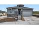 New construction two-story home featuring stone accents, a covered porch, and an attached two-car garage at 1871 Grayside Cir, Castle Rock, CO 80109