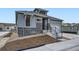 Attractive two-story home with modern siding, stone accents, a covered porch and an attached garage at 1871 Grayside Cir, Castle Rock, CO 80109