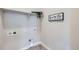 Clean laundry room offers essential hookups, shelving and trendy décor for functional convenience at 1871 Grayside Cir, Castle Rock, CO 80109