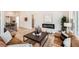 Open-concept living room featuring modern decor, a sleek fireplace, and hardwood flooring, bright space at 1871 Grayside Cir, Castle Rock, CO 80109
