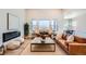 Inviting living room features a modern fireplace, stylish furniture, large windows, an open floor plan at 1871 Grayside Cir, Castle Rock, CO 80109