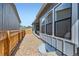 Side yard with gravel landscaping, fence, and large windows providing lots of natural light into the home at 1871 Grayside Cir, Castle Rock, CO 80109