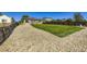 Extensive backyard features a vibrant lawn, enhanced by elegant stone details and fenced perimeter at 5280 Raritan Way, Denver, CO 80221