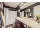 Bathroom featuring a combination shower and tub and a spacious vanity with a large mirror at 5280 Raritan Way, Denver, CO 80221