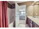 Bathroom with a shower, vanity, and a view into the bedroom at 5280 Raritan Way, Denver, CO 80221