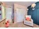 Cozy bedroom with carpet floors, a cozy armchair, and soft pink walls at 5280 Raritan Way, Denver, CO 80221