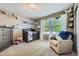 Bedroom featuring a crib, chair and bright natural light at 5280 Raritan Way, Denver, CO 80221