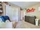 Light-filled bedroom with plush chair, neutral walls and carpet flooring at 5280 Raritan Way, Denver, CO 80221