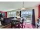 Open concept dining area with a view to the backyard, flowing into the living area, perfect for modern living and entertaining at 5280 Raritan Way, Denver, CO 80221
