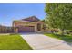Charming single-Gathering home with a well-maintained lawn, inviting front entrance, and two-car garage at 5280 Raritan Way, Denver, CO 80221