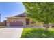 Charming single-Gathering home featuring a well-manicured lawn, mature tree, and a two-car garage with an inviting entry at 5280 Raritan Way, Denver, CO 80221