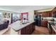 Modern kitchen featuring dark cabinets, black appliances, granite countertops, and wood flooring, perfect for cooking and entertaining at 5280 Raritan Way, Denver, CO 80221