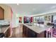 Modern kitchen featuring dark cabinets, granite countertops, and an open layout connecting to the living and dining areas at 5280 Raritan Way, Denver, CO 80221