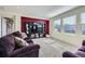 Spacious living room features custom built-ins, large windows, and comfortable seating at 5280 Raritan Way, Denver, CO 80221
