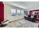 Cozy living room features large windows for natural light and a comfortable seating area at 5280 Raritan Way, Denver, CO 80221