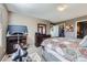 Spacious bedroom featuring a bed, television, dresser, and large windows at 5280 Raritan Way, Denver, CO 80221