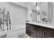 Bathroom with tiled shower/tub combo, a double sink vanity, and modern lighting at 4146 S Mobile Cir # A, Aurora, CO 80013