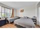 Bedroom featuring hardwood floors, a large window, and neutral decor at 4146 S Mobile Cir # A, Aurora, CO 80013
