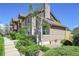 Side view of a tan two-story townhouse with mature landscaping and walkway at 4146 S Mobile Cir # A, Aurora, CO 80013