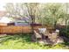 Backyard featuring a stone patio with wooden furniture, a yard, and a wooden fence at 7382 E 8Th Pl, Denver, CO 80230