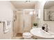 Bathroom featuring a glass-enclosed shower, vanity and plants at 7382 E 8Th Pl, Denver, CO 80230