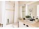 Cozy bathroom featuring a shower-tub combo with tiled walls, a large mirror, and a modern vanity at 7382 E 8Th Pl, Denver, CO 80230