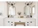 Elegant bathroom featuring double sinks, white cabinets, a vanity, and modern black fixtures at 7382 E 8Th Pl, Denver, CO 80230