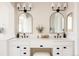 Elegant bathroom featuring dual sinks, modern fixtures, arched mirrors, and white cabinetry at 7382 E 8Th Pl, Denver, CO 80230