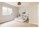 Bright bedroom with white walls, carpet, lamps, and big windows at 7382 E 8Th Pl, Denver, CO 80230