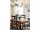 Elegant dining room features a wooden table with seating for six, stylish lighting, and neutral decor at 7382 E 8Th Pl, Denver, CO 80230