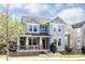 Charming two-story home featuring blue siding, white trim, a welcoming front porch, and well-manicured landscaping at 7382 E 8Th Pl, Denver, CO 80230