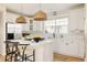 Modern kitchen featuring white cabinetry, stainless steel appliances, and hardwood floors at 7382 E 8Th Pl, Denver, CO 80230