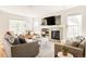 Cozy living room with a fireplace, comfortable seating, neutral decor, and plenty of natural light at 7382 E 8Th Pl, Denver, CO 80230