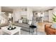 Living room with open floor plan showcasing modern furnishings, hardwood floors, and ample natural light at 7382 E 8Th Pl, Denver, CO 80230