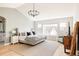 Spacious main bedroom with a large window, hardwood floors, and modern furnishings at 7382 E 8Th Pl, Denver, CO 80230