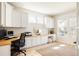Well-lit home office with custom built-in cabinets, a spacious desk, and ample storage for productivity at 7382 E 8Th Pl, Denver, CO 80230