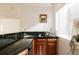 Granite wet bar with wood cabinets, sink and a natural light window at 7382 E 8Th Pl, Denver, CO 80230
