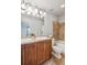 Well-lit bathroom featuring a double vanity with wood cabinets and a shower-tub combination at 9066 Apache Plume Dr # E, Parker, CO 80134