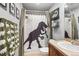 Fun bathroom featuring a dinosaur-themed shower curtain and quirky decor, creating a playful space at 9066 Apache Plume Dr # E, Parker, CO 80134