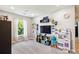 Bright bedroom with toys, shelves, and a window with natural light, offering a playful ambiance at 9066 Apache Plume Dr # E, Parker, CO 80134