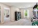 A well-lit bedroom with modern gray walls and a carpeted floor, next to another bedroom at 9066 Apache Plume Dr # E, Parker, CO 80134
