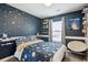 Comfortable bedroom with space themed decor, constellations on the wall, and a cozy chair at 9066 Apache Plume Dr # E, Parker, CO 80134
