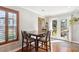 Bright dining area boasts natural light from french doors and window with wooden shutters at 9066 Apache Plume Dr # E, Parker, CO 80134