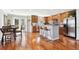 Kitchen with island seating, stainless steel appliances, wood cabinets, and eat in dining area at 9066 Apache Plume Dr # E, Parker, CO 80134