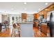 Spacious kitchen features a peninsula with barstool seating, modern appliances and sunlit eating area at 9066 Apache Plume Dr # E, Parker, CO 80134